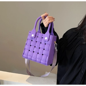 Detail of purple EVA woven bag featuring matte cross-weave texture and shoulder strap