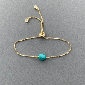 Detail of adjustable 14K gold-plated box chain with turquoise stone and crystal ends