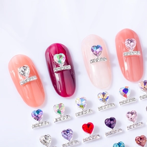 Sparkling heart-shaped nail gems in multiple colors set on metallic silver bases