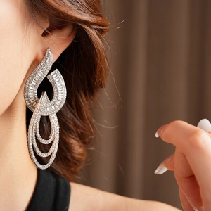 Close-up of elegant silver hollow circle earrings with sparkling diamonds on model
