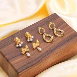 French vintage 18k gold plated bow earrings with pearls and crystals on silk background