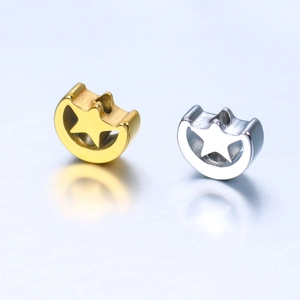 Close-up of polished stainless steel moon and star charms in gold and silver finish