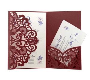Macro shot of burgundy laser-cut lace invitation suite with floral inner card detail
