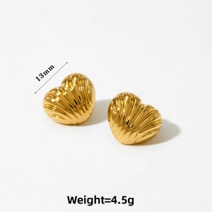 Detail of gold heart earrings showing 13mm size and unique textured metal surface