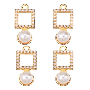 Macro detail of four gold pearl and zircon pendants for DIY jewelry making