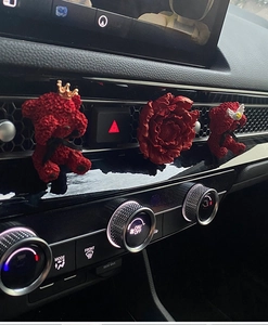Car air vent clips with red crown bear and peony flower diffusers in car interior