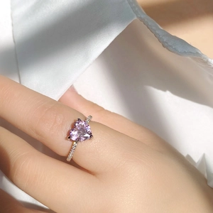 Elegant heart-shaped pink diamond ring in silver setting worn on finger for a chic look