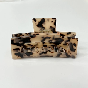 Detail view of square tortoiseshell hair claw clip with sturdy metal spring mechanism
