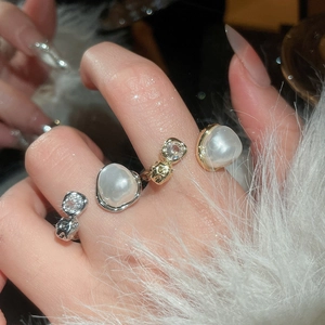 Detailed view of layered pearl ring with sparkling zircon in vintage French style