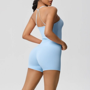 Detail view of sky blue yoga set featuring a criss-cross back top and high-waist shorts