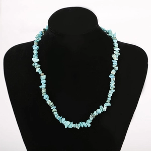 Handmade turquoise chip stone necklace displayed on a black velvet mannequin bust