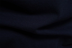 Close-up of the breathable dark blue knitted fabric showing texture and stitching details