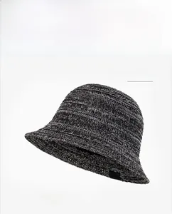 Detail of breathable dark gray hand-knitted bucket hat with textured fabric for women