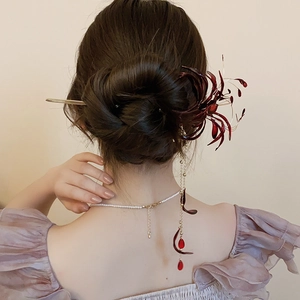 Detail of red Lycoris flower hair stick with golden tassels and beaded drops