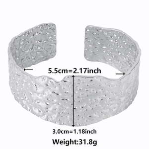 Detail showing the hammered texture of an adjustable wide silver stainless steel cuff bangle