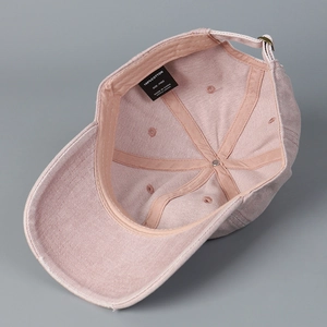 Faded pink cotton baseball cap featuring embroidered letters and vintage distressed edges