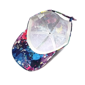 Inside view of graffiti baseball cap showing white lining and polyester material tags
