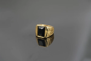 Detailed close-up of a vintage gold men's ring with a black rectangular gemstone inlay