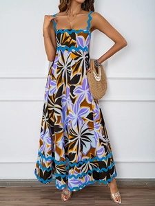 Detailed view of the vibrant floral maxi dress with unique blue scallop trim on the hemline