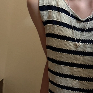 Minimalist S925 sterling silver heart pendant necklace on striped knitted top