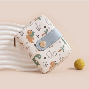 Close-up of cute cartoon dinosaur print on cream white PU leather short wallet with blue clasp