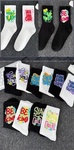 Detail view of assorted cotton athletic crew socks with colorful graffiti text patterns