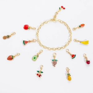 Gold charm bracelet set with colorful fruit enamel pendants like cherry and strawberry
