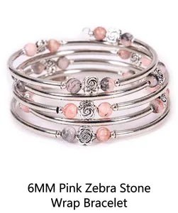 Detail of 6mm pink zebra stone beads and silver rose charms on a multi-layer wrap bracelet