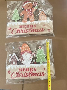 Detail of wooden Christmas door signs with Merry Christmas text and measuring tape for scale