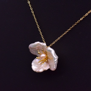 Baroque pearl flower necklace in 925 silver with a gold chain on black leather