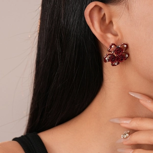 Detailed view of vintage rose stud earrings featuring faux pearls and sparkling crystals