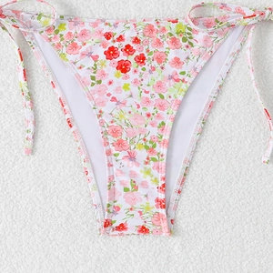 Close-up of white bikini bottom with floral print and adjustable side ties