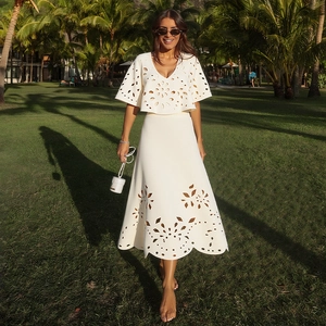 Elegant white laser-cut deep V-neck crop top and high-waisted A-line maxi skirt set