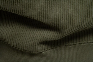 Macro texture of olive green ribbed knit fabric on a men's stand collar sweatshirt