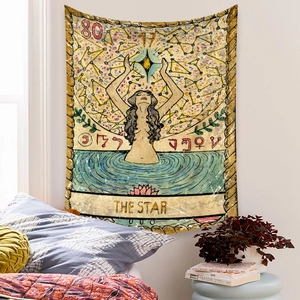 Detail of The Star tarot tapestry with vintage illustration hanging in a cozy bedroom
