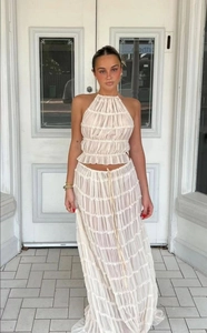Detail of off-white halter top and tiered maxi skirt set featuring layered ruffle fabric