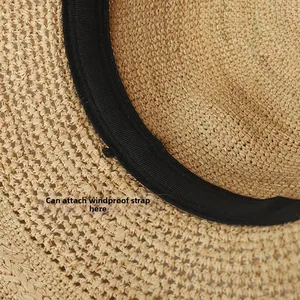 Detail of raffia sun hat showing black sweatband and windproof rope attachment point