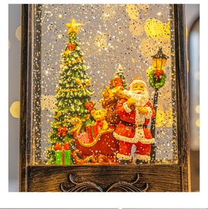 Detail of Christmas lantern with Santa, reindeer and swirling snow inside a vintage frame
