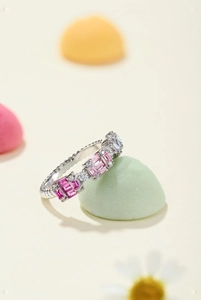 Detail view of silver ring with pink and clear baguette-cut cubic zirconia crystals