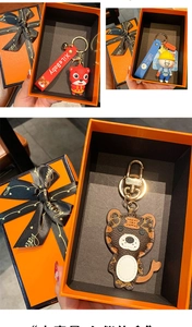 Exquisite gift box showcasing assorted cartoon keychains with premium leather textures