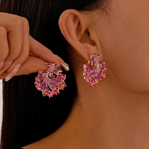 Chinese-style koi fish earrings with colorful crystals on a golden metal base