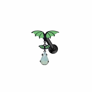 Detail of black metal bat piercing jewelry with green wings and a teardrop crystal