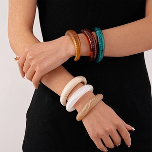 Vintage chunky acrylic bangles set with textured stripes in amber and green tones