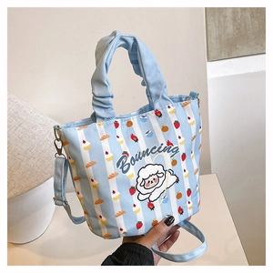 Detail of blue and white striped canvas bucket bag with cute cartoon sheep embroidery