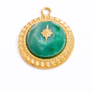 Detailed view of a gold star relief on a green agate pendant with textured golden edges