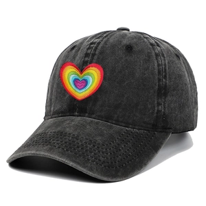 Detail of embroidered rainbow heart on vintage washed cotton baseball cap texture