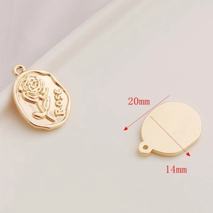 Detailed view of 14K gold-filled oval rose pendant measuring 20mm x 14mm with embossed flower