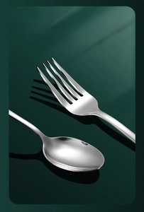 Polished stainless steel cutlery set with mirror finish fork and spoon on dark background