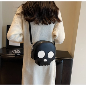 Rear view of a model wearing a quirky skull-shaped crossbody bag with white eye contrast