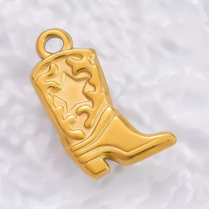 Detailed close-up of a gold-plated cowboy boot pendant with engraved star on white background